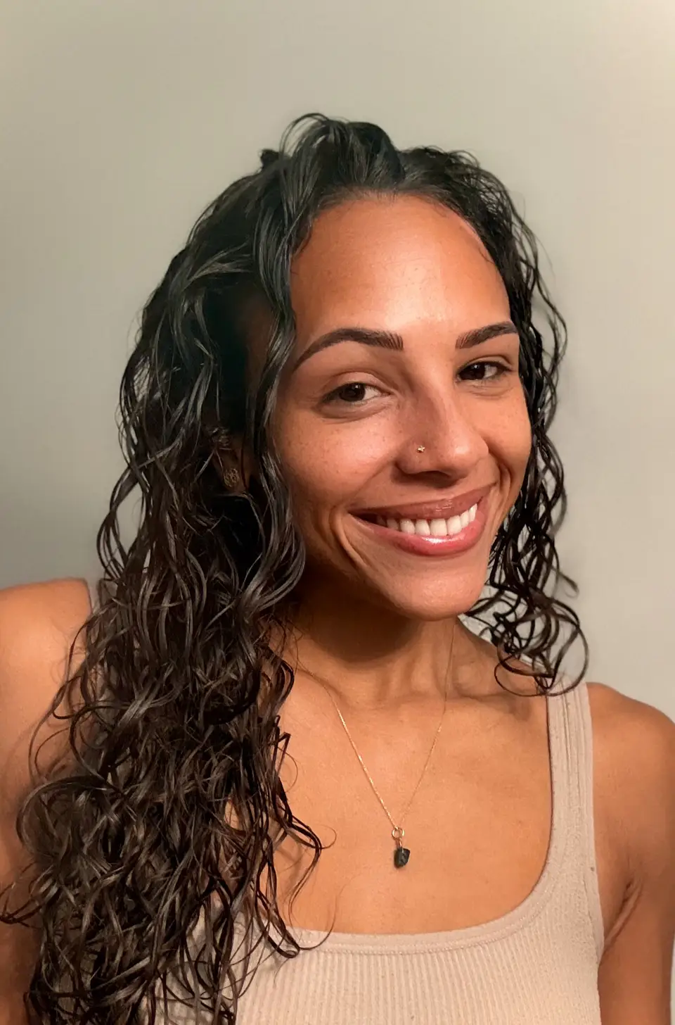 Angelica Jade Altman, smiling, curly hair, warm light